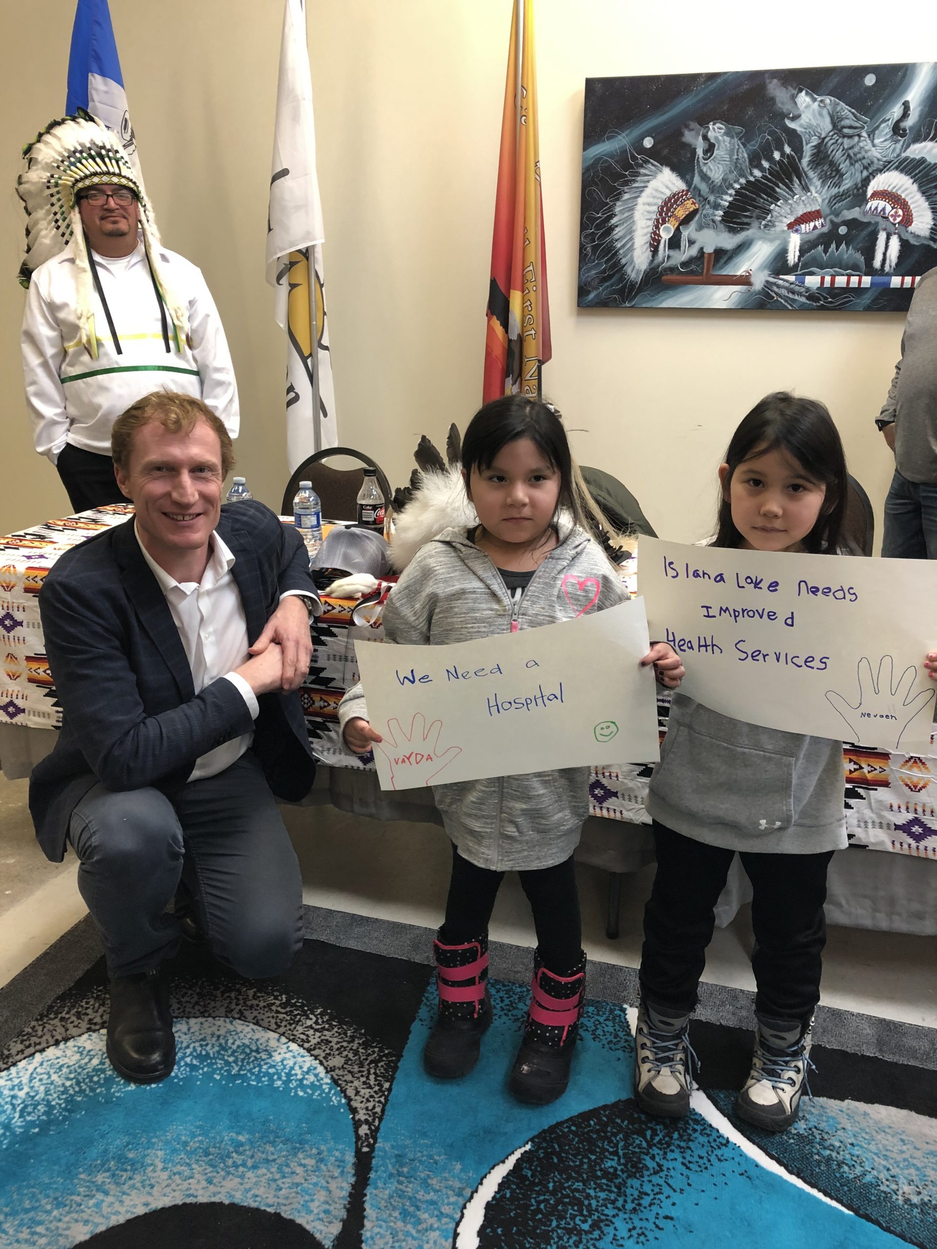 Read more about the article Minister Miller With Children Of Island Lake Communities Holding Up Posters